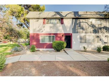 Charming two-story townhome featuring a well-maintained front yard and cozy curb appeal at 565 Greenbriar Townhouse Way, Las Vegas, NV 89121