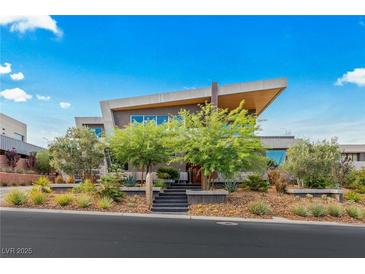 Stunning modern home with unique roofline, professional landscaping, and striking architectural design at 8 Meadowhawk Ln, Las Vegas, NV 89135