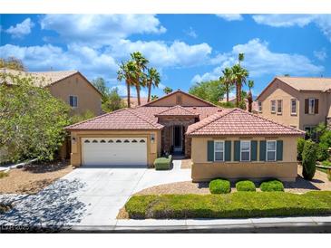 Charming single-story home with a well-manicured lawn, a two-car garage, and a beautiful tile roof at , Las Vegas, NV 89113