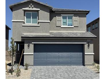 Charming two-story home featuring a gray stucco facade, and a two-car garage, offering a cozy, modern living space at 10406 Luna Mezza Ave # Lot 192, Las Vegas, NV 89141