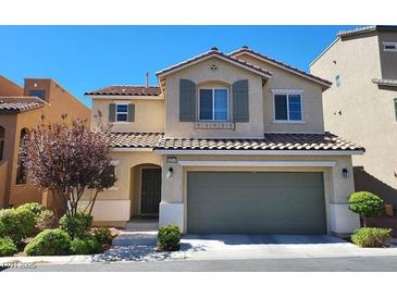 Charming two-story home features a tile roof, neutral stucco, shutters, and a two-car garage at 10717 Red Badge Ave, Las Vegas, NV 89166