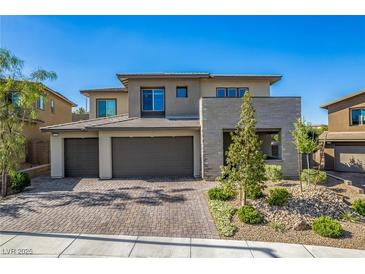 Modern two-story home featuring a three-car garage and well-maintained front yard landscaping at 12332 Switchgrass Ave, Las Vegas, NV 89138