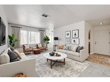 Bright living room features contemporary decor, plush seating, and large windows for natural light at 1846 N Decatur Blvd # 104, Las Vegas, NV 89108