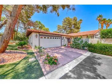 Charming single story home featuring a brick driveway, two car garage and desert landscaping at 2101 Plaza Del Fuentes, Las Vegas, NV 89102