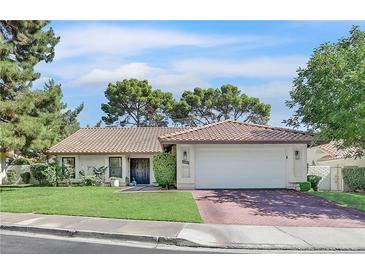 Charming single-story home with a tile roof, well-manicured lawn, and a two-car garage at 3220 Calle De El Cortez, Las Vegas, NV 89102
