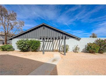 A cozy single-story home featuring low maintenance landscaping and a contemporary pergola at the entrance at 3924 Blackford Pl, Las Vegas, NV 89102