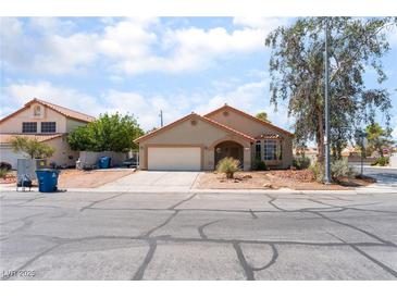 A charming single-story home with a well-maintained yard and attached two-car garage at 4335 Twin Peaks Dr, North Las Vegas, NV 89032