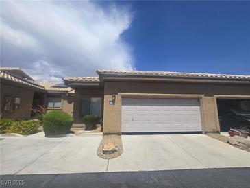 Charming single story home featuring an attached two car garage and desert landscaping at 4764 Wild Draw Dr, North Las Vegas, NV 89031