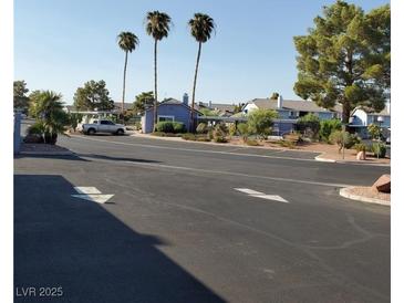 Residential street scene with palm trees, parking, and well-maintained landscaping at 5841 Medallion Dr # 102, Las Vegas, NV 89122