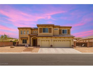 Two-story home featuring a tile roof, three car garage, neutral stucco, and a welcoming entry with stone accents at 6351 Abacus Farms Ct, Las Vegas, NV 89131