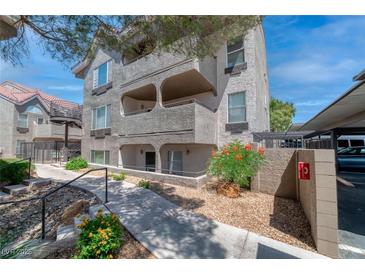 Condominium building featuring a textured facade, landscaped walkway, and covered parking at 701 Capri Dr # 6A, Boulder City, NV 89005