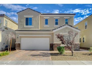 Charming two-story home featuring a brick driveway, a two-car garage, and a neatly landscaped front yard at 8531 W Oquendo Rd, Las Vegas, NV 89113