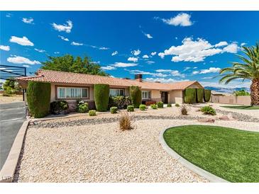 Charming single-story home with desert landscaping, green lawn, and mature trees on a sunny day at 9660 W Ann Rd, Las Vegas, NV 89149