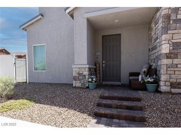 Charming front entrance with stone accents, neat gravel landscaping, and a welcoming porch seating area at 226 Callen Falls Ave # 1311, Henderson, NV 89011