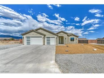 Attractive single-story home with a spacious three-car garage and a low-maintenance desert landscape at 4801 Stoneham, Pahrump, NV 89061
