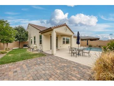Well-maintained backyard featuring a pool, patio, and lush lawn, ideal for outdoor enjoyment at 489 Intonation St, Henderson, NV 89011