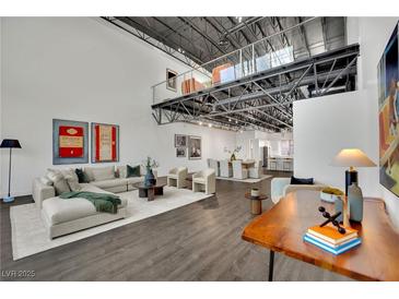 Bright, modern living room featuring a spacious seating area, unique overhead loft, and stylish decor with an open floor plan at 5015 Thunder River Cir, Las Vegas, NV 89148
