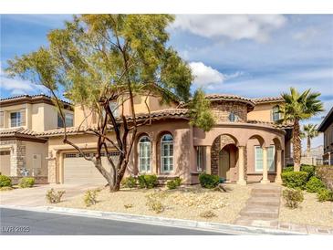 Charming two-story home featuring a stucco exterior, tiled roof, and a well-maintained, xeriscaped front yard at 12116 Vista Linda Ave, Las Vegas, NV 89138