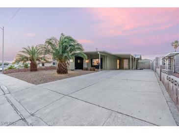 Charming single-story home boasts a spacious driveway, desert landscaping and an attached carport at 1628 Izabella Ave, Las Vegas, NV 89169