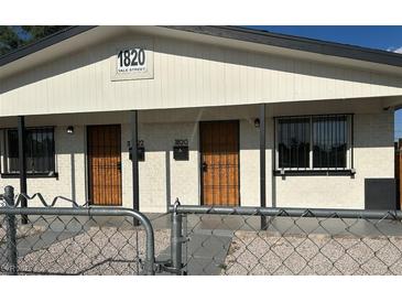 Inviting home exterior featuring a dual entrance and security doors for peace of mind at 1820 Yale St, North Las Vegas, NV 89030