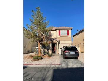 Charming two-story home featuring red shutters, a well-kept lawn, and a private driveway on a sunny day at 2190 Clancy St, Las Vegas, NV 89156