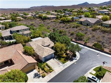 Expansive aerial view of a charming community with lush landscaping and mountain views at 42 Glade Water Dr, Henderson, NV 89052