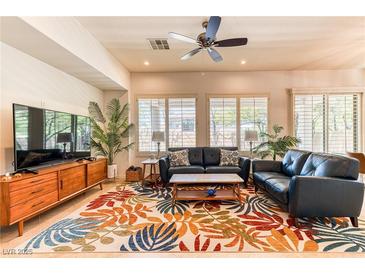 Inviting living room with ample natural light, stylish decor, and comfortable seating arrangement at 42 Glade Water Dr, Henderson, NV 89052