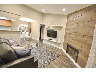Inviting living room featuring a fireplace, modern furnishings, and an open floor plan at 4200 S Valley View Blvd # 3074, Las Vegas, NV 89103