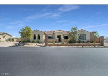 Charming single-story home featuring a desert-landscaped front yard, wrought iron fence, and a tile roof at 5812 Shangri La Night Ct, Las Vegas, NV 89149
