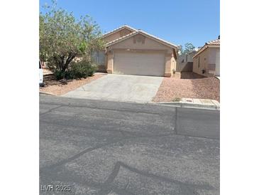 Cozy single-story home featuring a two-car garage and desert landscaping at 6470 Shining Sand Ave, Las Vegas, NV 89142