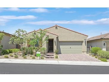 Charming single story home with a desert landscaped front yard and a brick paved driveway at 701 Webber Park St, Henderson, NV 89011