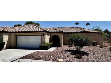 Charming single-story home featuring a tile roof, two-car garage, and mature landscaping at 7273 Vista Bonita Dr, Las Vegas, NV 89149