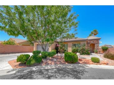 Charming single-story home featuring a landscaped front yard, desert foliage, and a stone-accented entryway at 7606 Kenwood Hills Ct, Las Vegas, NV 89131