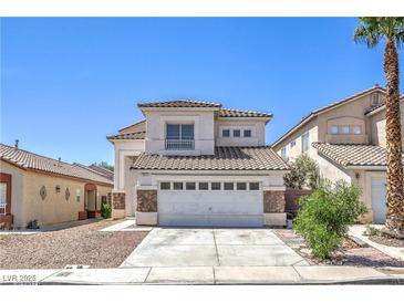 Charming two-story home with a tile roof and stone accents, plus a two-car garage and low-maintenance landscaping at 7977 Blue Brook Dr, Las Vegas, NV 89147