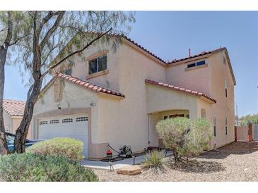Charming two-story home featuring a two-car garage and low maintenance landscaping at 9091 Jumping Jacks Ave, Las Vegas, NV 89178