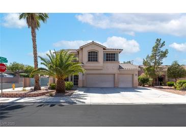 Charming two-story home featuring a three-car garage, desert landscaping, and a welcoming facade at 1063 Silver Star St, Henderson, NV 89002