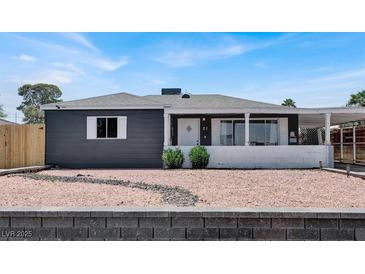 Charming single-story home featuring a gray exterior, white trim, and low-maintenance landscaping at 21 Laswell St, Henderson, NV 89015