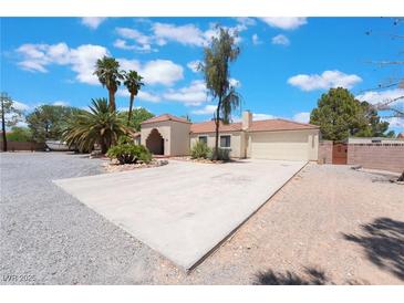 Charming single-story home with a desert-landscaped front yard, large driveway, and a two-car garage at 4530 W Shelbourne Ave, Las Vegas, NV 89139