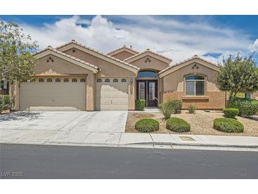 Inviting single-story home with a three-car garage and well-maintained desert landscaping at 9252 Oxbow Lake Ave, Las Vegas, NV 89149