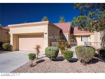 Charming single-story home featuring a red tile roof, well-manicured landscaping, and an attached two-car garage at 9424 Gold Mountain Dr, Las Vegas, NV 89134