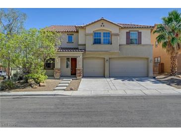 Charming two-story home featuring a spacious three-car garage and a well-maintained front yard at 2261 Dalton Ridge Ct, North Las Vegas, NV 89031