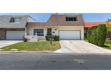 Charming home featuring well-maintained landscaping, a two-car garage, and a welcoming entrance at 3785 Decade St, Las Vegas, NV 89121