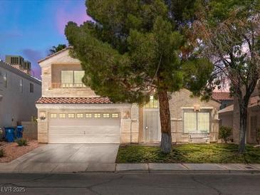 Inviting two-story home featuring a two-car garage and well-maintained front yard at 7924 Mcdowell Dr, Las Vegas, NV 89129