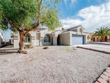 Charming single-story home featuring stucco siding, a blue garage door, and low-maintenance desert landscaping at 849 Brahma Ln, Henderson, NV 89002