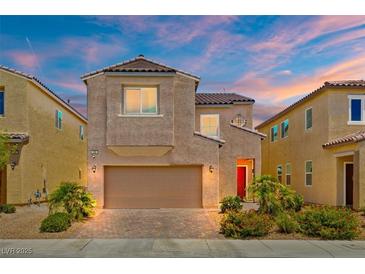 Beautiful two-story home featuring a two-car garage, desert landscaping, and a charming red front door at 106 Rock Crossing Ave, North Las Vegas, NV 89031