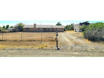 Ranch-style home with brick exterior, large lot and separate outbuilding, plus mature landscaping at 1400 Silver Peak Ave, Pahrump, NV 89048