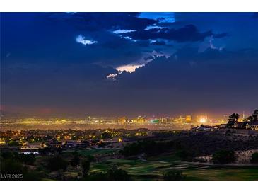Striking Las Vegas city view featuring the skyline and a golf course at dusk at 2786 Scotts Valley Dr, Henderson, NV 89052