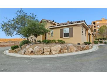 Charming home featuring a well-maintained yard with natural rock landscaping at 4 Via Centrale # 1, Henderson, NV 89011