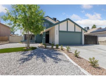 Charming two-story home with a lush tree in the front yard and a well-maintained lawn at 6999 Montcliff Ave, Las Vegas, NV 89147
