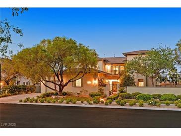 Beautiful home featuring manicured landscaping and inviting curb appeal with mature trees at 1404 Reisling Ct, Las Vegas, NV 89144